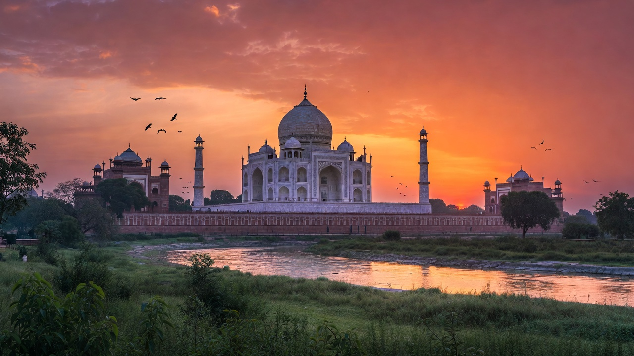 Taj Mahal reflected in water at sunset